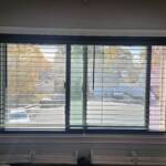 custom wood black blinds in a bedroom