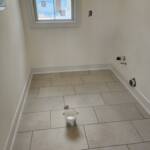 new porcelain tile flooring installed in a laundry room