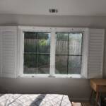 custom window shutters in a bedroom
