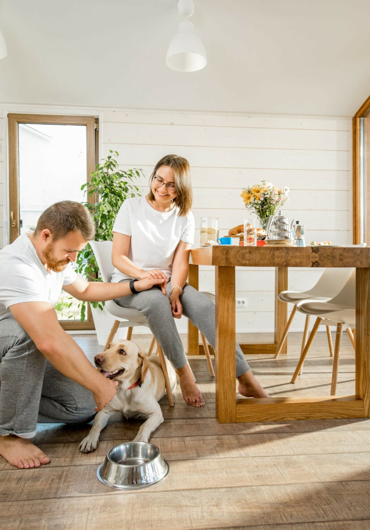 Young couple with dog at home | Nationwide Floor & Window Coverings